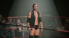 Jack (Stephen Amell) standing alone in the wrestling ring in Heels season 2, with fans at ringside, holding a microphone.